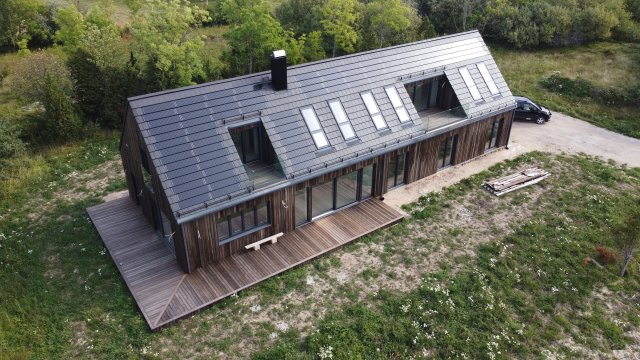 Integrated solar roof panels installed on a modern summer residence. Solarstone.